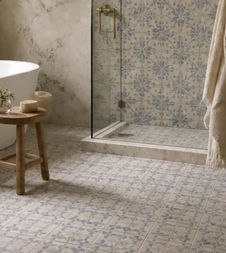 Bathroom with a freestanding tub and a patterned Portuguese tile floor