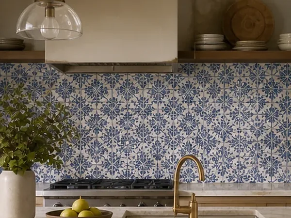 Kitchen with a blue and white Portuguese tile backsplash, brass tap and marble island